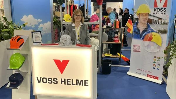 Frau am Messestand von Voss Helme auf der PSI-Messe